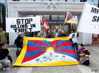 On March 18, protesters gather around burning debris in the streets of Lhasa, Tibet