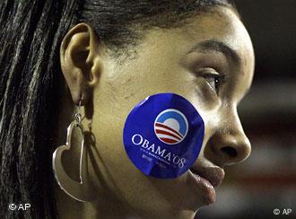 A young woman wears an Obama campaign sticker on her cheek