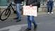 A protester in Berlin holds a sign saying "Corona is a psy op"