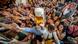 Young people reach out for free beer in one of the beer tents on the opening day of the 187th Oktoberfest beer festival in Munich